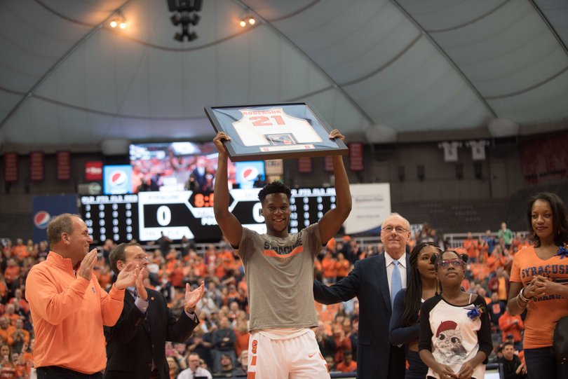 Tyler Roberson holds up his jersey on Senior Day. The senior forward has scored in double figures only seven times this season.