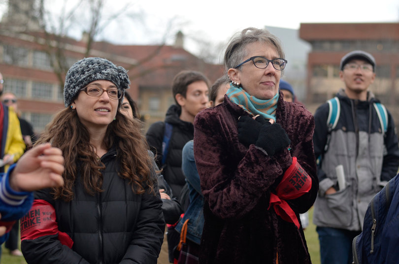 Jackie Orr (right) and 
Ivy Kleinbart (left) both stand in the cold on Wednesday afternoon for the Women’s Day Sanctuary Campus Rally.