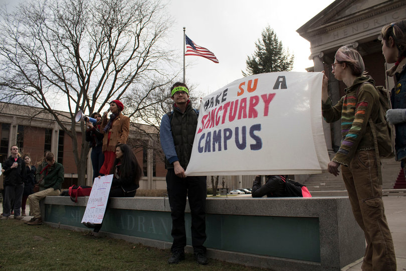 Students hold a sign throughout the entire rally that says "Make SU A Sanctuary Campus."
