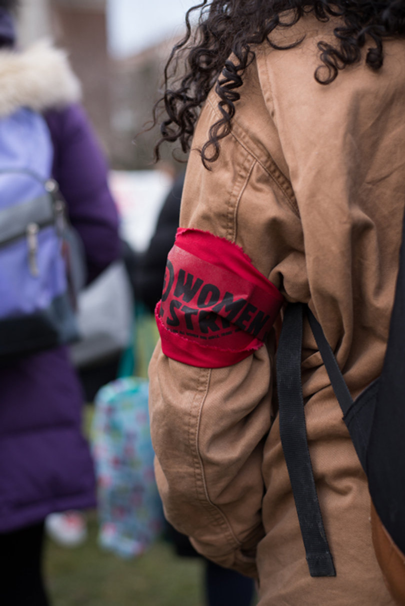 A demonstrator wears a red "Women's Strike" armband which were distributed by the Women's and Gender Studies department.