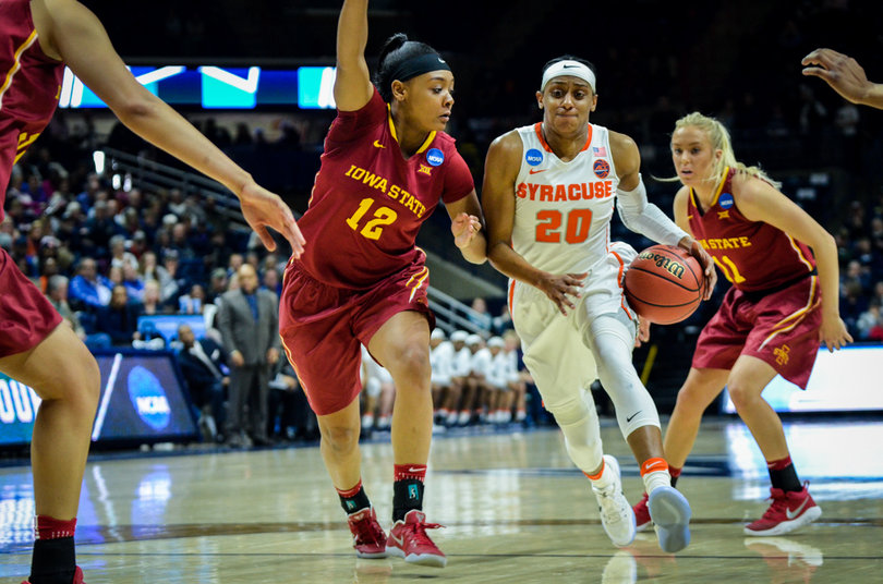 Sykes powers her way toward the hoop while dribbling the ball in her left hand.