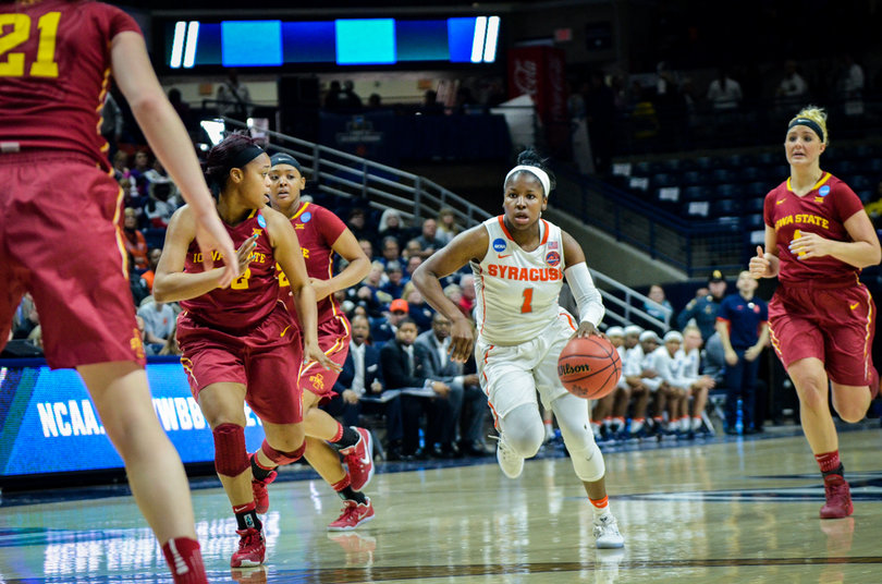 Alexis Peterson drives toward the basket with four Iowa State defenders around her.