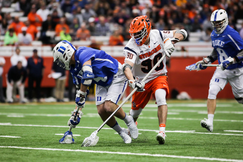 Fusco reaches his long stick down to try and scoop a ground ball. 