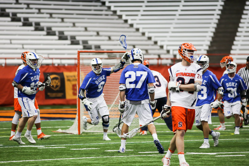 Sean Lowrie celebrates a goal as Molloy and other Orange players turn away. 