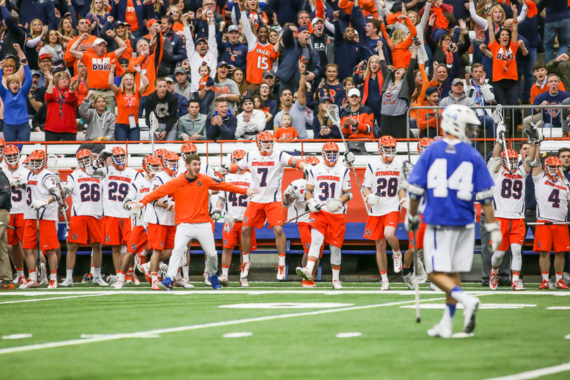 The Orange bench, and fans behind them, celebrate. 