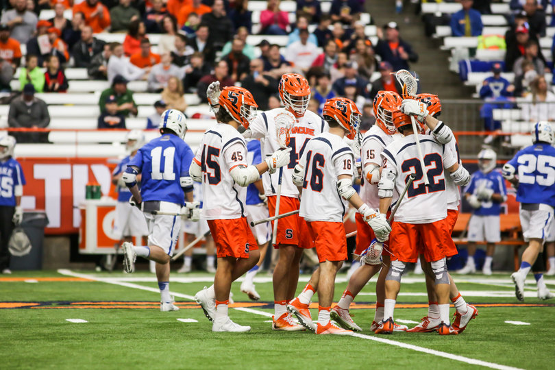 SU celebrates and huddles up after scoring. 
