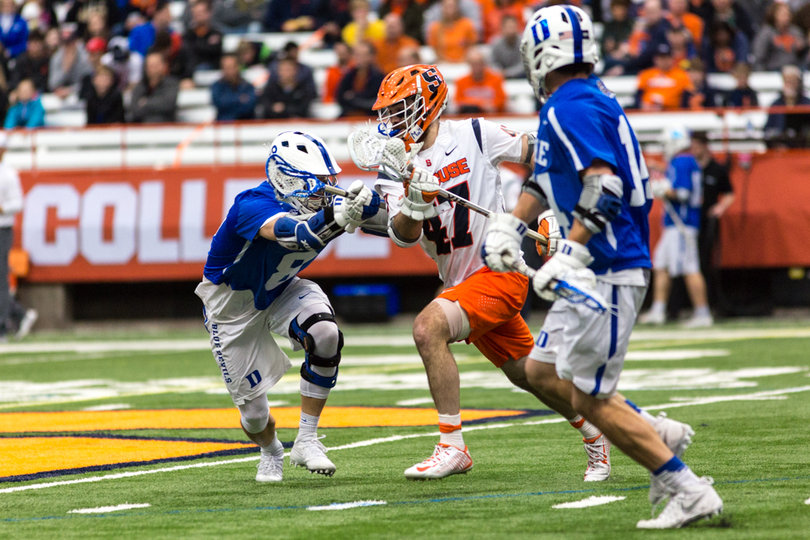 Joe Gillis tries to split two Duke defenders. 