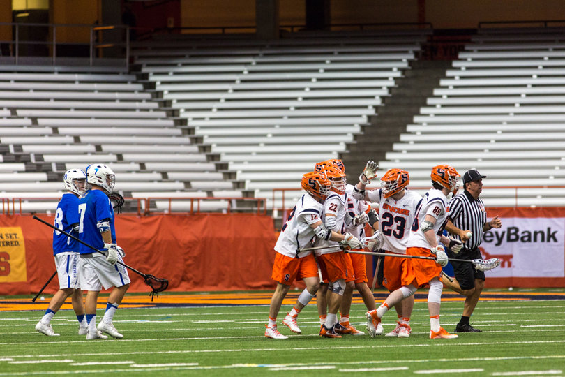 The Orange runs off the field after celebrating a goal. 
