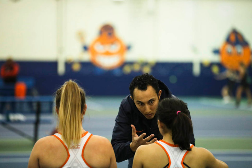 Limam talks with his first doubles duo before the start of the game. 