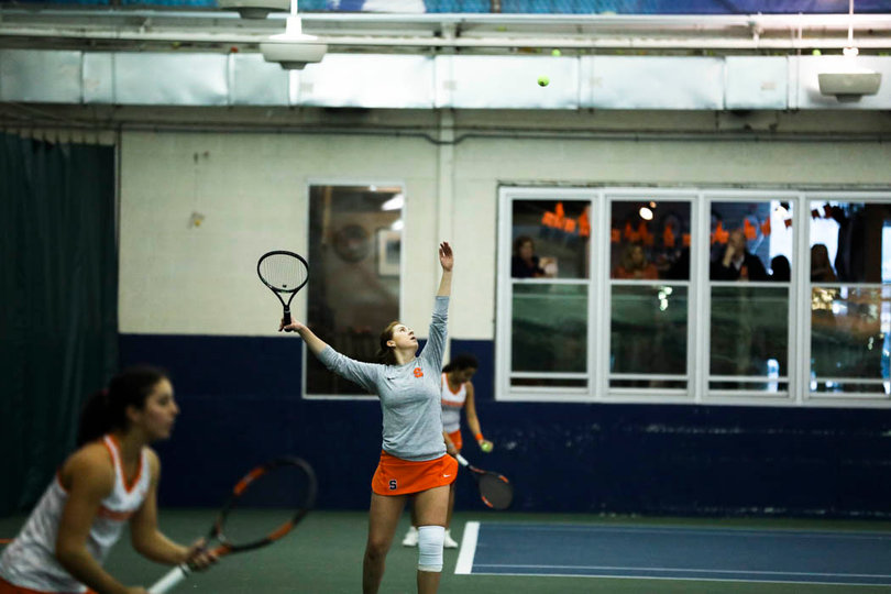 Shkudun throws the ball up for a serve. 