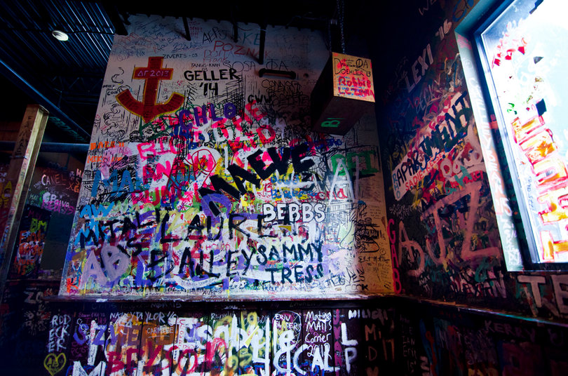Writing your name on the wall is a tradition at the bar.