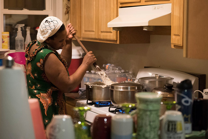 The family cooks a meal to enjoy while they celebrate being together again.