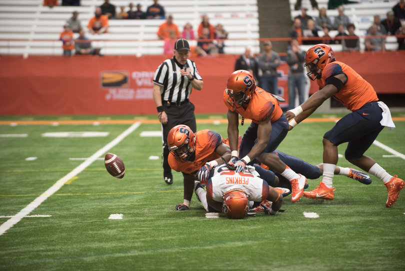 Three Team Orange defenders blow up running back Tyrone Perkins in the backfield. 
