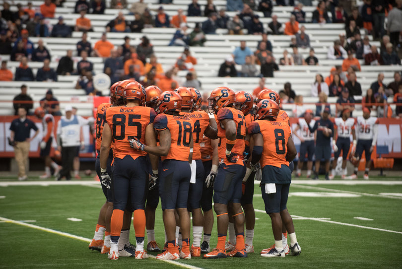 Team Orange — comprised of first-team players — huddles on the field. 