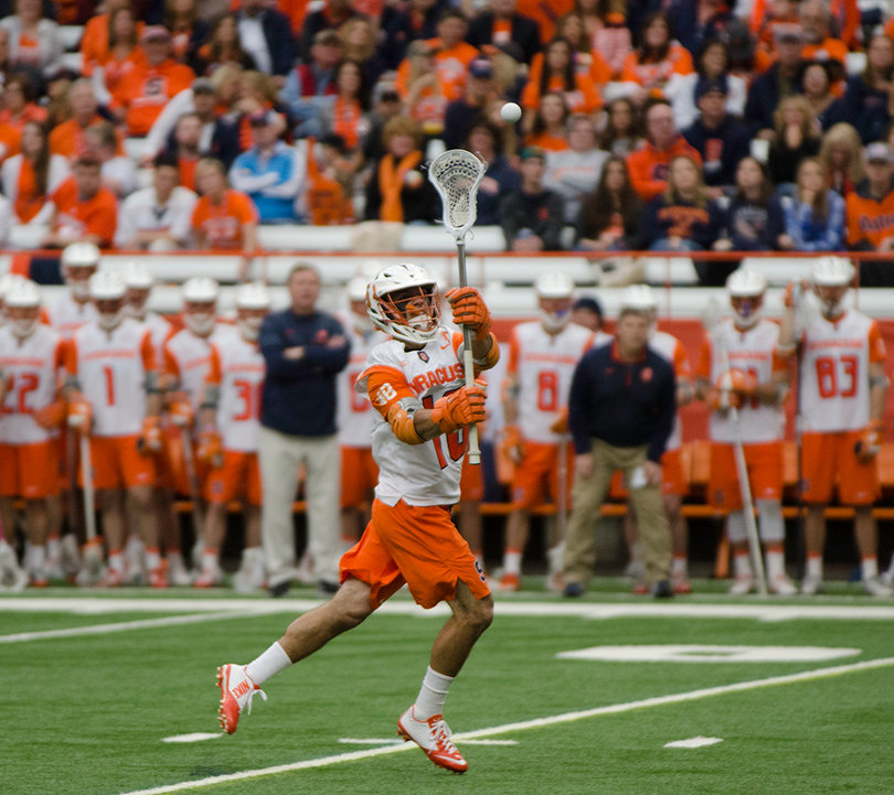 SU head coach John Desko, in the background, said afterward that the game was close because SU turned the ball over too much (13). 