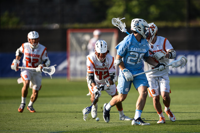 Brendan Bomberry scoops up a ground ball behind Ryan Macri. 