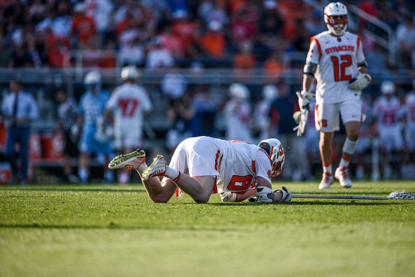 Andrew Helmer falls to the ground. The long-stick midfielder had an assist to close defenseman Tyson Bomberry.