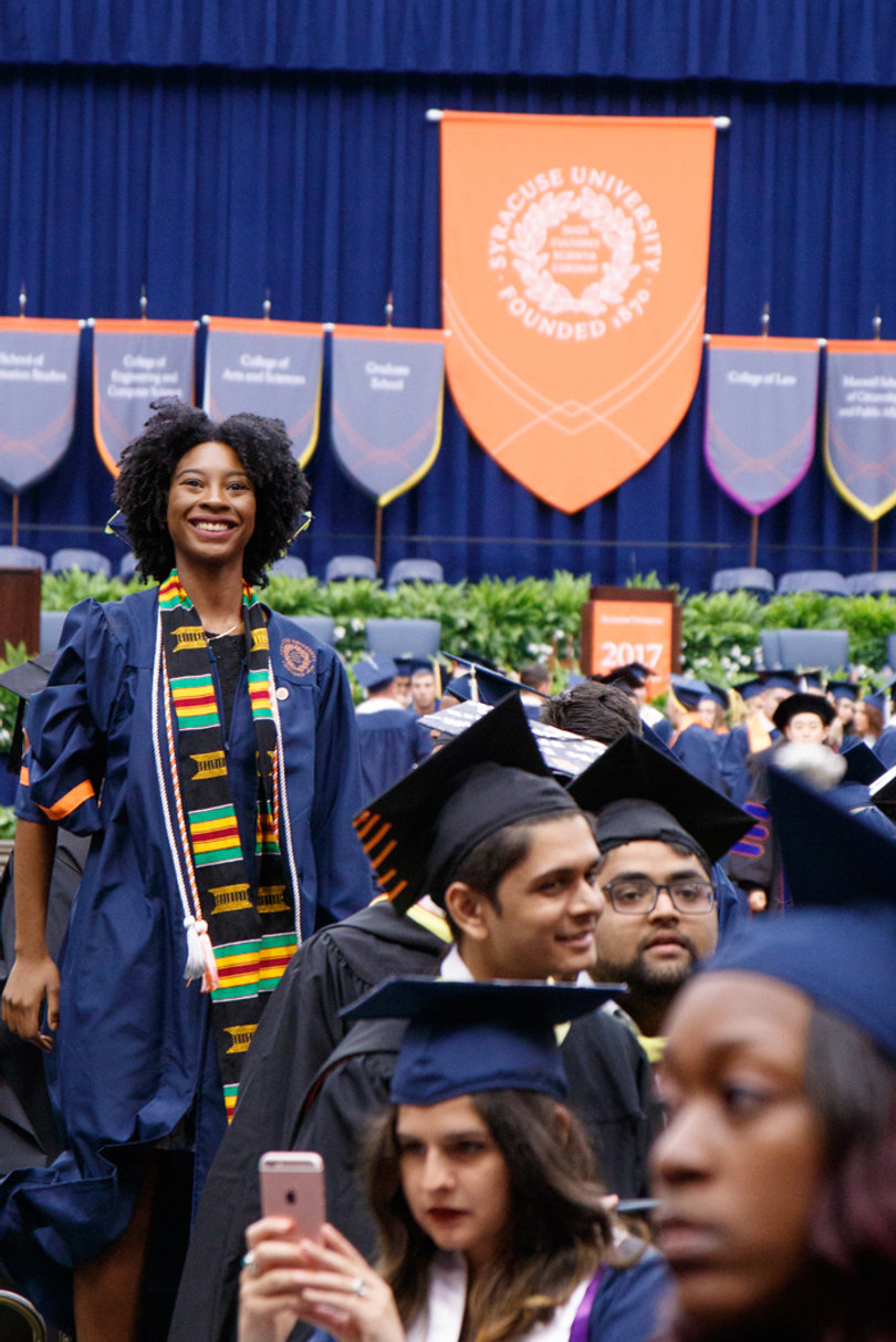 A student smiles prior to the start of the commencement ceremony. 