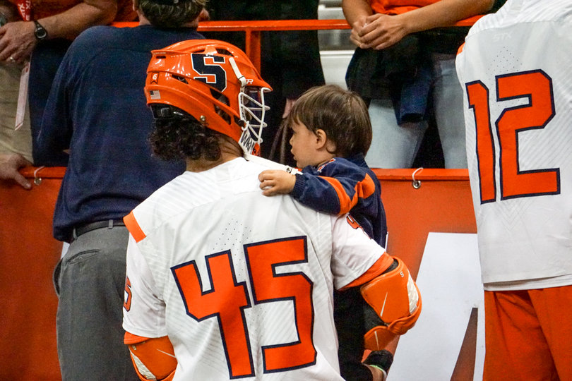 Junior attack Brendan Bomberry celebrates the win with his son, Jagger Bomberry. 