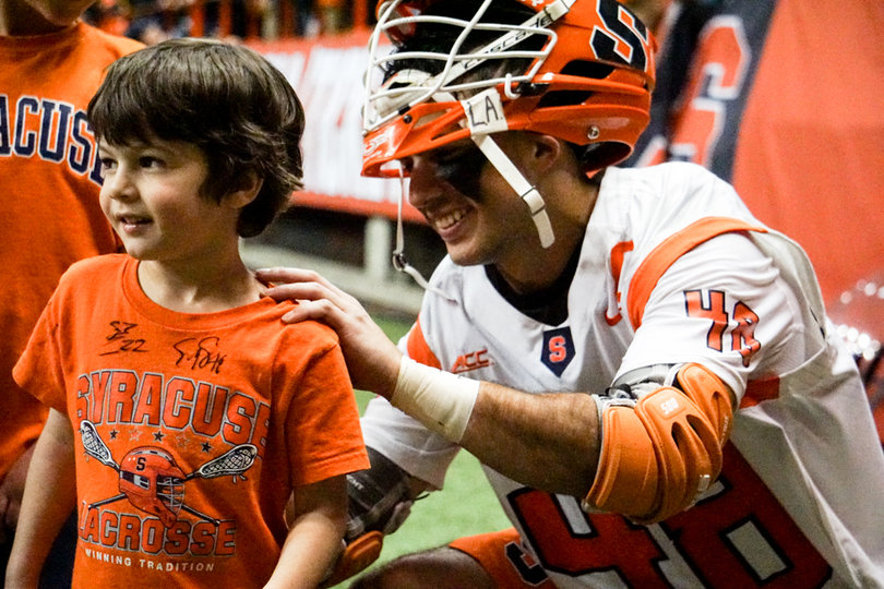 Senior midfielder Sergio Salcido signs a young fan's t-shirt. 