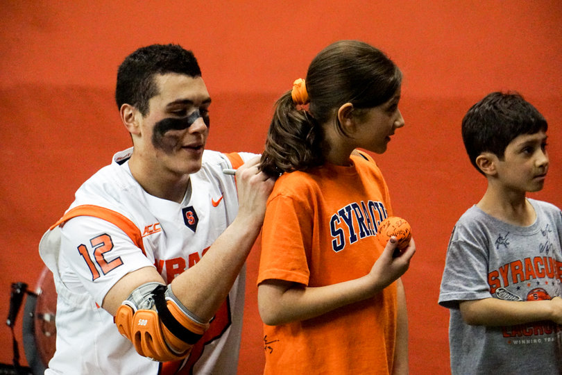 Trimboli signs a fan's t-shirt. 