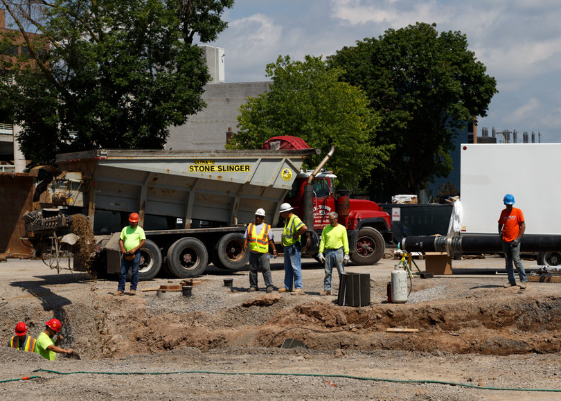 Gravel is being tossed into a trench as work continues on the sewer line upgrade project on Waverly Avenue. Photo taken July 18, 2017
