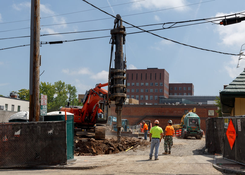Construction crews watch as machinery drills into the ground along South Crouse Avenue. Photo taken July 18, 2017