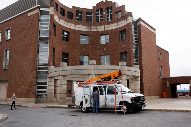 A physical plant vehicle sits in front of White Hall building, where classroom improvements are being made. Photo taken July 25, 2017