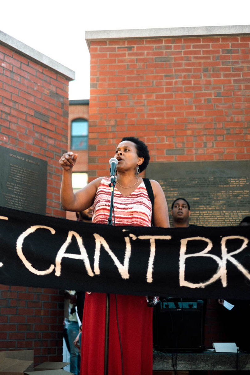 Individuals shared their thoughts at the podium by the Jerry Rescue statue. Banners that said "WE CAN'T BREATHE" were held in front of many speakers. 