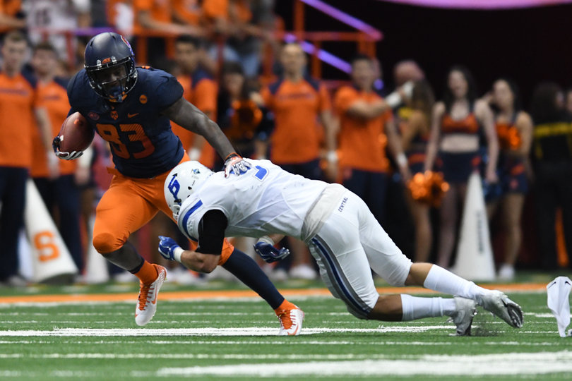 Redshirt senior receiver Sean Avant (83) cradles the football and tries to escape an arm tackle. 