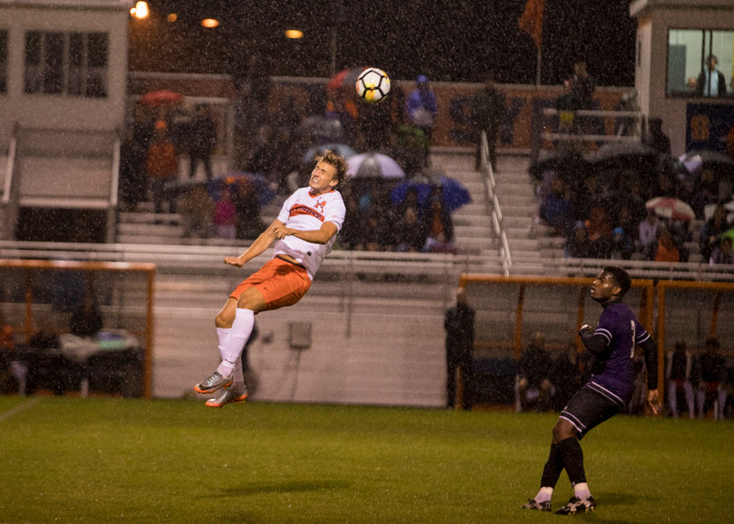 Stangeland heads the ball as rain falls. 
