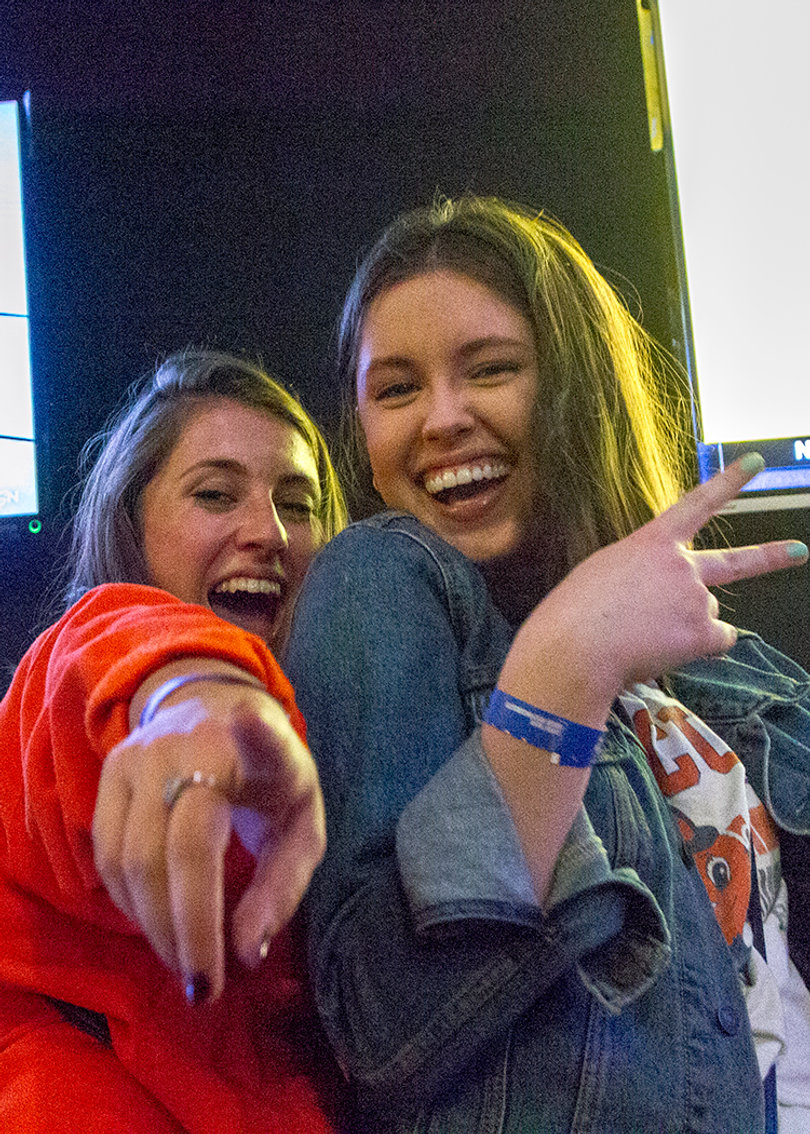 Elayna Milano and Melissa Cubit enjoy the grand reopening of Orange Crate, which has been owned by R.C. Faigle, a Syracuse University alumnus, for 22 years.