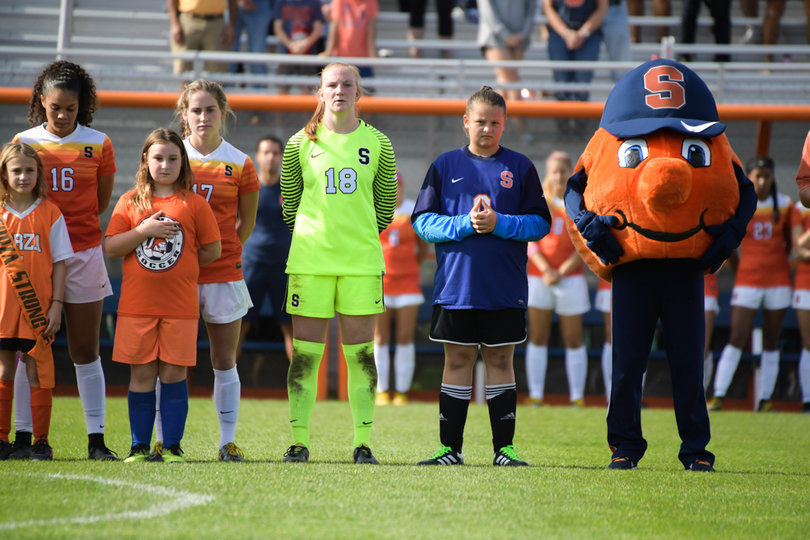 The Orange stands with with Otto for its last home national anthem playing for their college careers. 