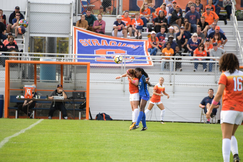 Two players collide in going for a header. 