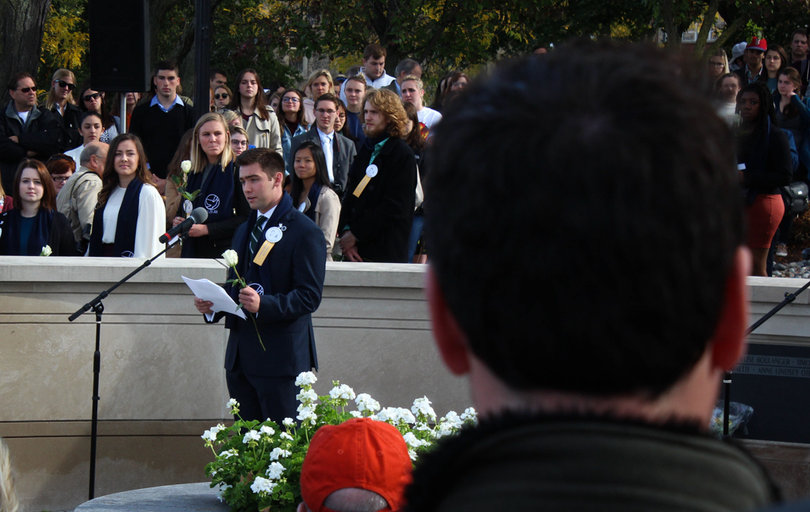 Each scholar had a moment to say a few words before placing their rose along the wall on Friday. 