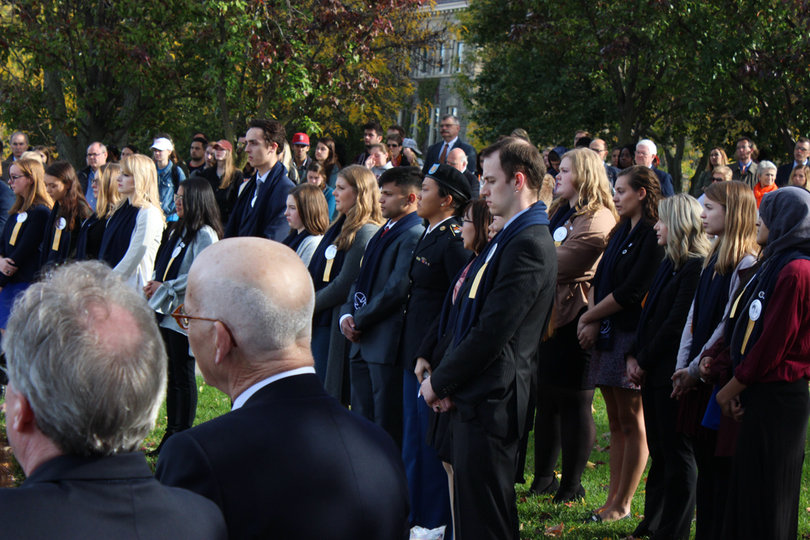 Dozens of SU community members watched as the scholars placed roses on the Wall of Remembrance. 
