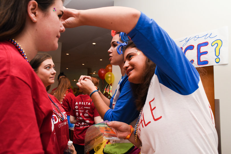 Jackie Abrams put face glitter on each of the participants in the event. 