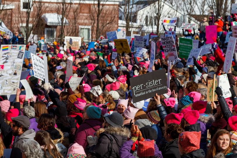 Several demonstrators donned pink, pointy-eared "pussyhats." The caps have become a symbol of the Women's March. 
