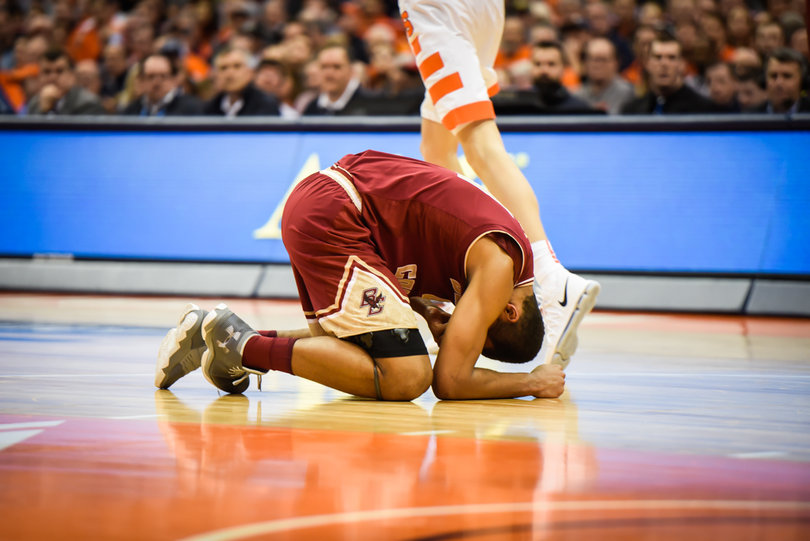 A Boston College player loses his footing running across the court.