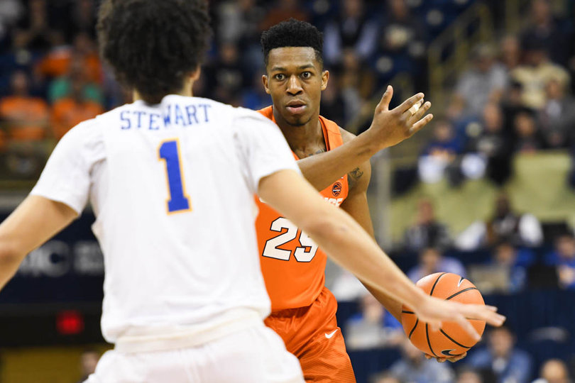 Battle signals to his teammates as he dribbles in the offensive end.