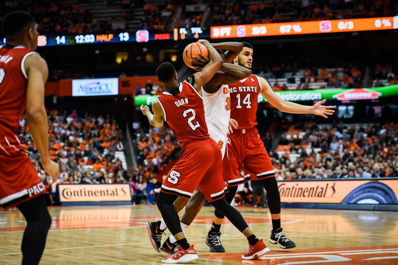Bourama Sidibe is stripped of the ball by two NCSU defenders. 