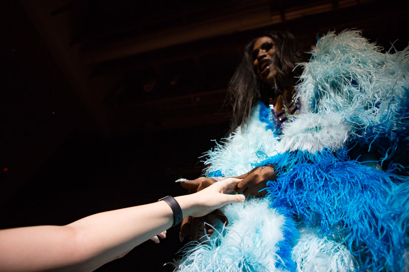 Couleé reaches out to touch a fan while onstage.