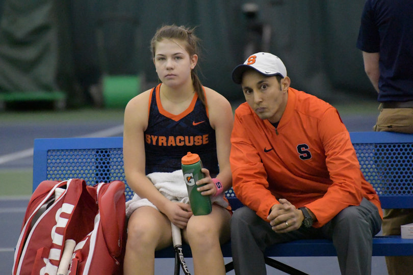 Syracuse head coach Younes Limam sits with Golubovskaya during her match on Sunday.