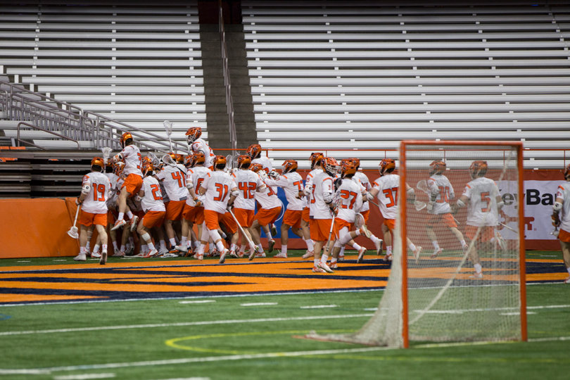 Syracuse mobs Simmons after he scored the game winner in overtime.