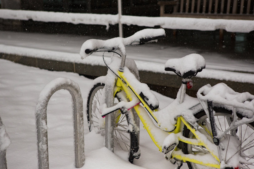 A bicycle is covered in snow as a major snowstorm rolls through central New York on Friday.