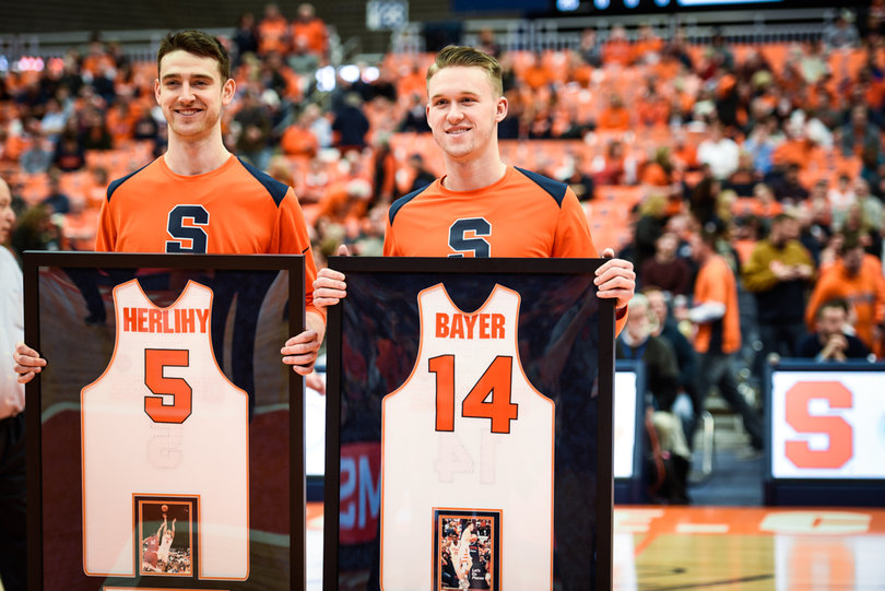 Seniors Patrick Herlihy and Braedon Bayer held their framed jerseys as they were honored for men's basketball Senior Day at the Carrier Dome.