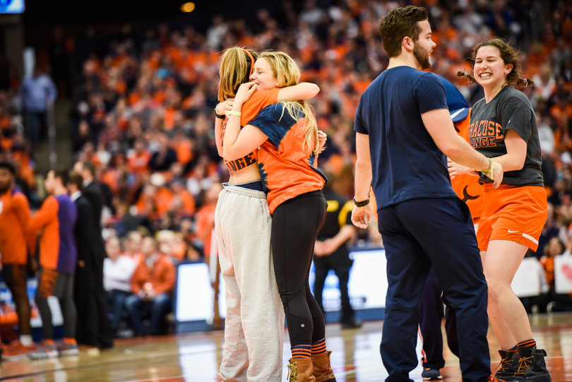 Seven students and Otto the Orange ran out onto the court during the game, and they revealed which students were Otto the Orange throughout their last four years at Syracuse.