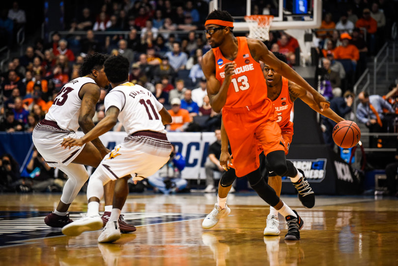 Junior Paschal Chukwu sets a screen for Battle. Chukwu, SU's 7-foot-2 center, knocked down clutch free throws late in the game to preserve SU's lead. 