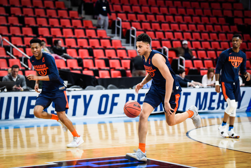 Moyer, Battle and Howard run a drill together during practice.