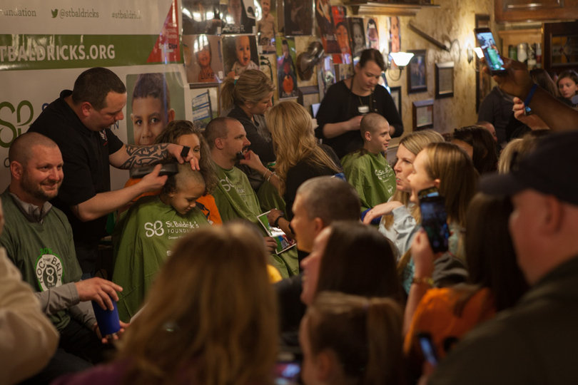 Spectators packed the bar to to watch and record friends and family go bald for the cause.